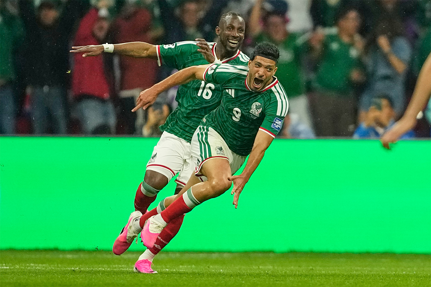 Mexico's Raul Jimenez runs to celebrate on the field.