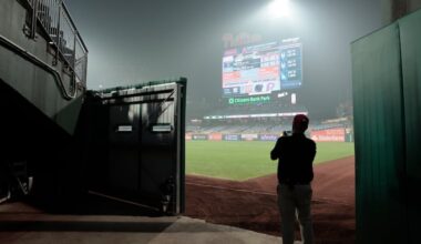 Phils logistics team member Erik Lowell takes a photo of the smoke filled air over the baseball field after the New York Mets at Philadelphia Phillies MLB baseball game at Citizens Bank Park in Philadelphia.