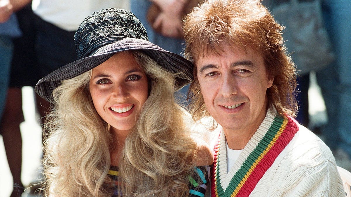 Bill Wyman and Mandy Smith smiling together for a photo in 1989.