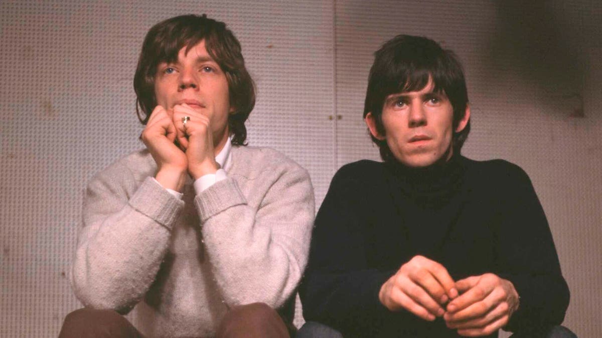 Mick Jagger and Keith Richards sitting together on a set in London.