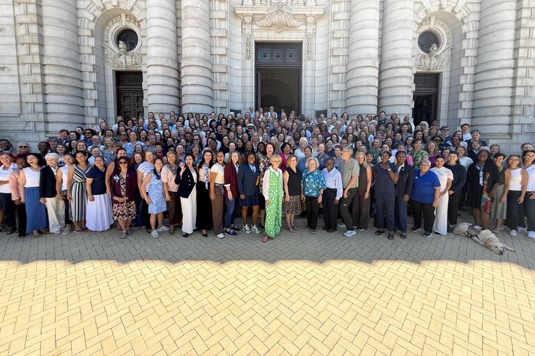 Female alumni posed for a photo in front of Bancroft Hall to celebrate the 50th anniversary of the first co-ed class.