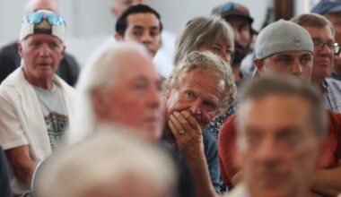 A man listened during a public meeting after a sewer break forced the closure of clamming flats.