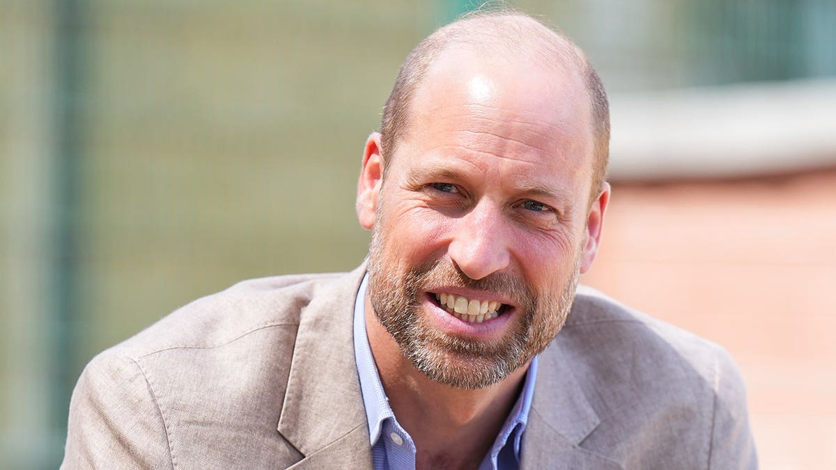 A close-up of Prince William in a tan suit.
