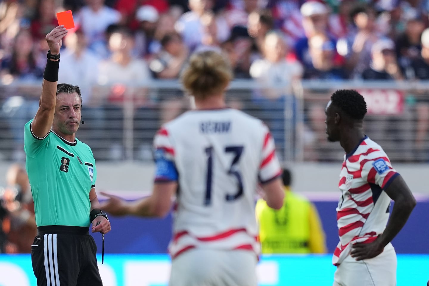 Referee Raphael Claus of Brazil shows a red card to United States' Folarin Balogun, right, during the World Cup round of 32 soccer match between the United States and Bosnia and Herzegovina in Santa Clara, Calif. on Wednesday.