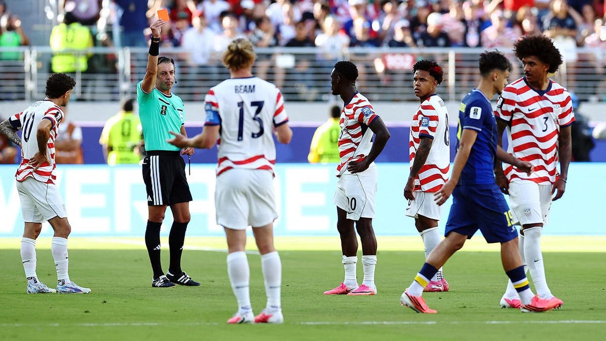 A referee shows a red card during a World Cup match