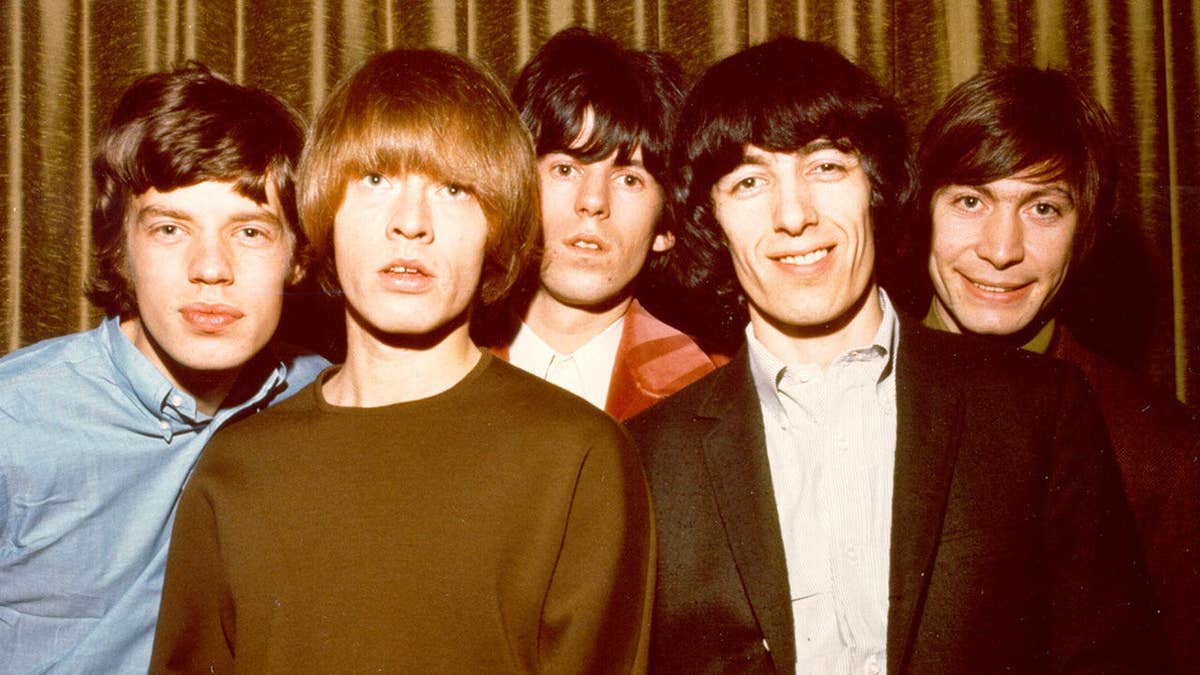 The Rolling Stones posing for a photo together in 1964.