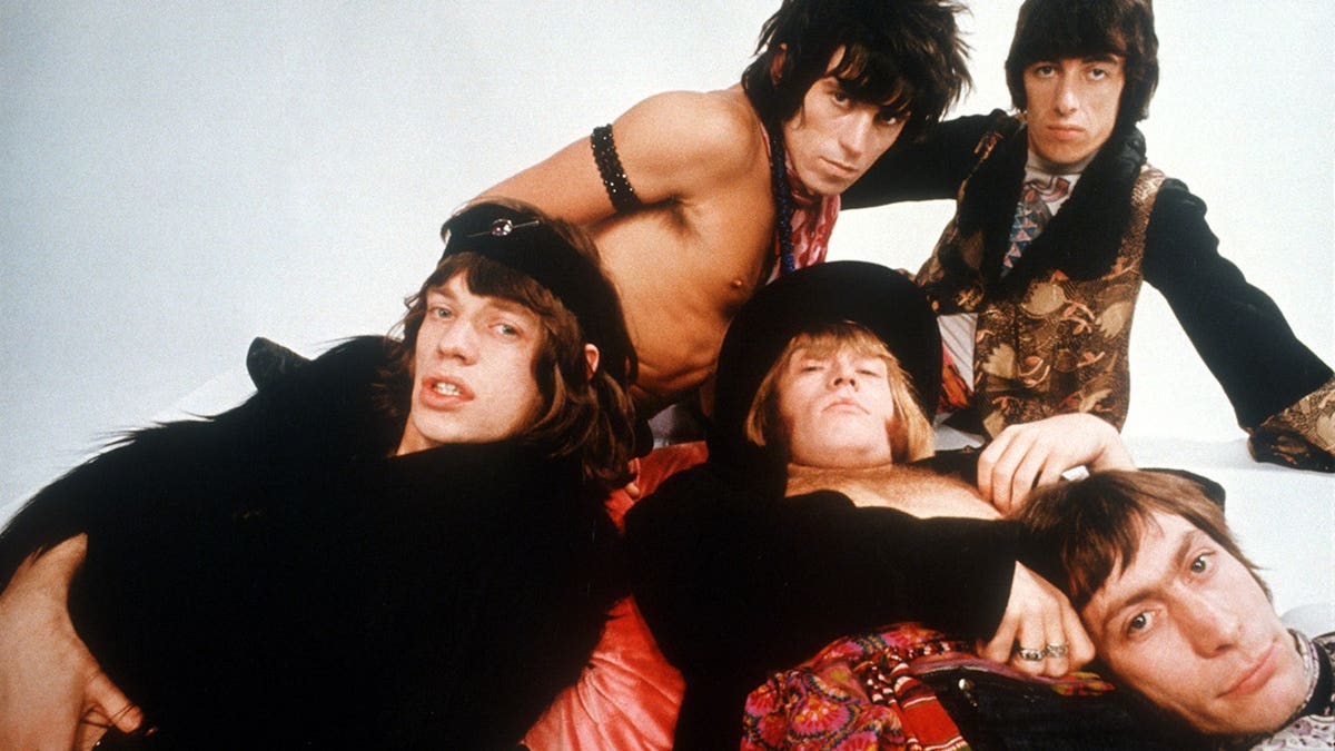 The Rolling Stones lying down for a glamorous photo.
