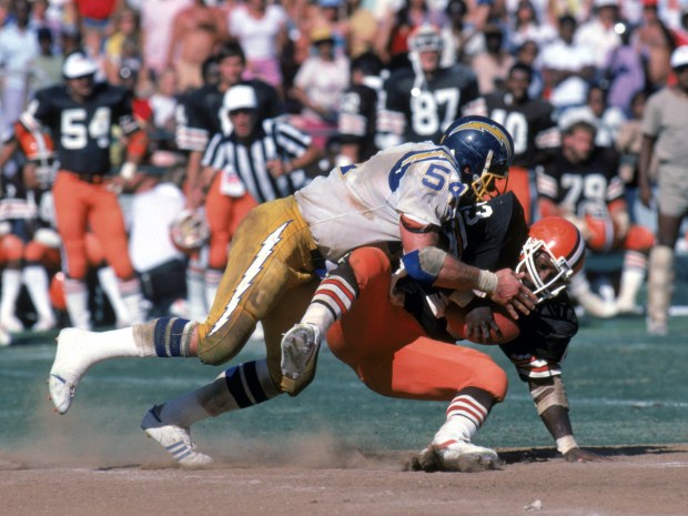 SAN DIEGO - SEPTEMBER 25: Full back Mike Pruitt #43 of the Cleveland Browns gets taken down by linebacker Billy Ray Smith #54 of the San Diego Chargers during a game at Jack Murphy Stadium on September 25, 1983 in San Diego, California. The Browns won 30-24 in overtime. (Photo by George Rose/Getty Images)