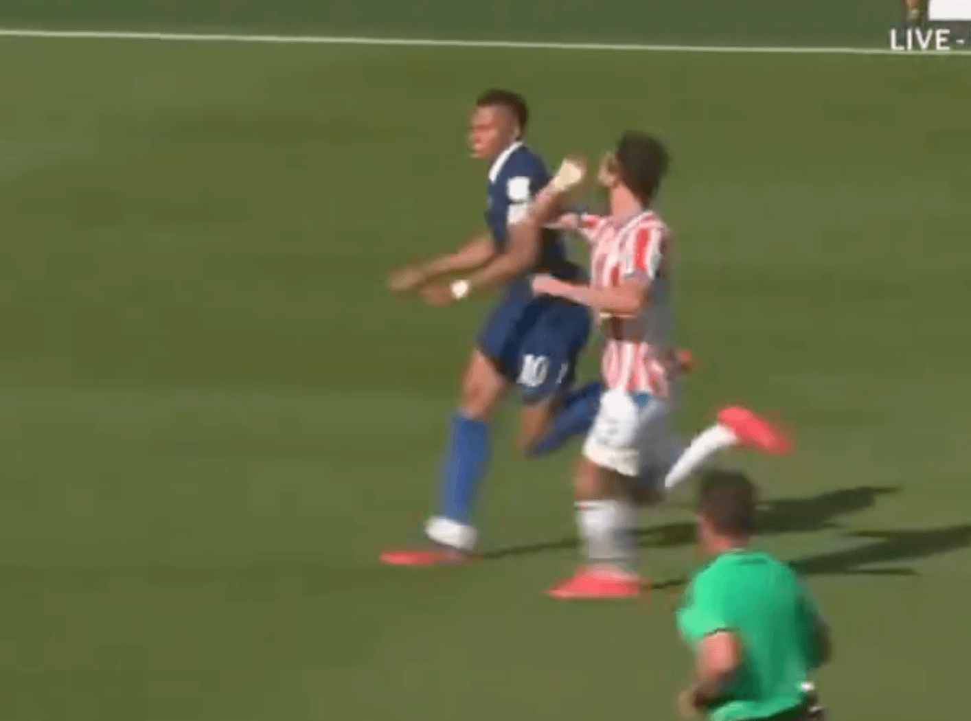 Matias Galarza raises his arm as he prepares to collide with Kylian Mbappe