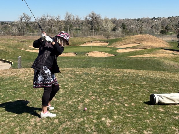 Lauren Dundon of Denver hits off of the tee box on the eighth hole of the Par 3 South course at the Greg Mastriona Courses at Hyland Hills in Westminster on April 5, 2026. Yes, her shot landed in one of the many bunkers, which are hard to miss (but good practice getting out of). (Barbara Ellis, The Denver Post)