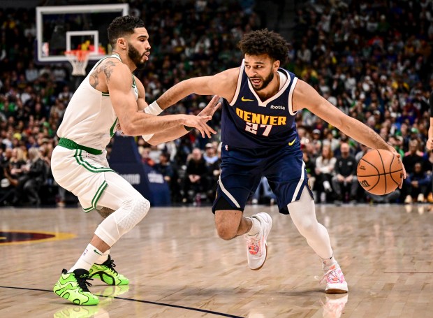 Jamal Murray (27) of the Denver Nuggets handles as Jayson Tatum (0) of the Boston Celtics during the first quarter at Ball Arena in Denver on Tuesday, Jan. 7, 2025. (Photo by AAron Ontiveroz/The Denver Post)