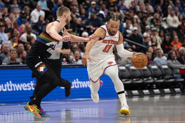 Jalen Brunson (11) of the New York Knicks is defended by Christian Braun (0) of the Denver Nuggets on Friday, March 6, 2026, at Ball Arena in Denver. (Photo by Timothy Hurst/The Denver Post)