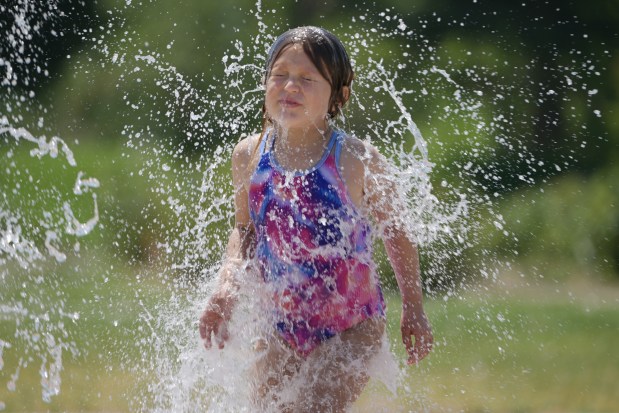 Sofie Rodgers, 6, of Denver cools off in the H2O Odyssey, a water jet fountain, at City Park in Denver on Tuesday, July 21, 2026. (Photo by Hyoung Chang/The Denver Post)