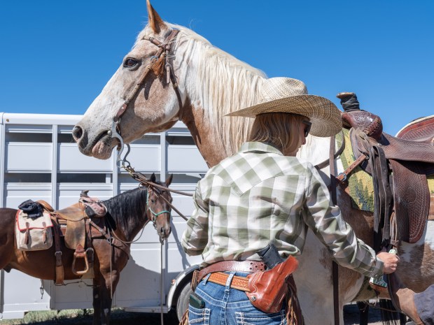 Christina Vander Berg prepares for a ride in search of signs of wolf activity near Collbran on June 17, 2026. (Photo by William Woody/Special to The Denver Post)