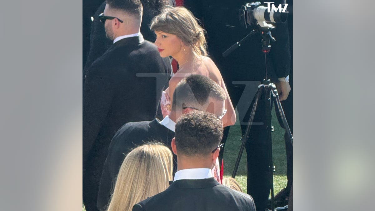 Taylor Swift photographed in pink floral dress at wedding