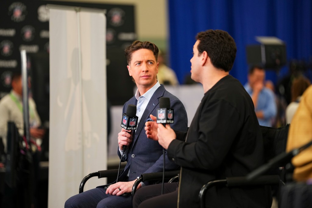 Two men in chairs holding NFL Network microphones, one listening intently while the other speaks.