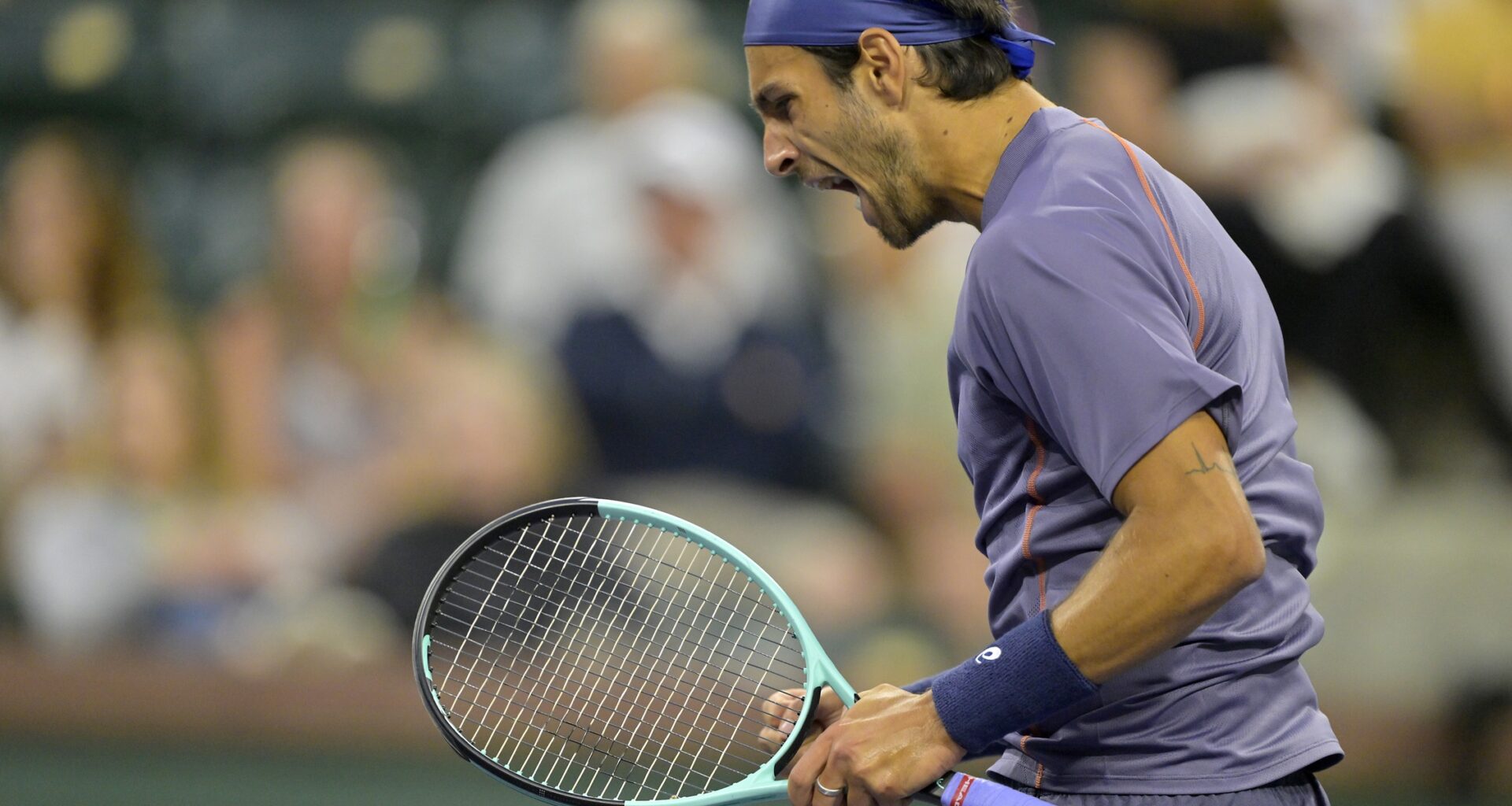 Lorenzo Musetti celebrates winning a set against Arthur Fils at the BNP Paribas Open in Indian Wells in 2025.