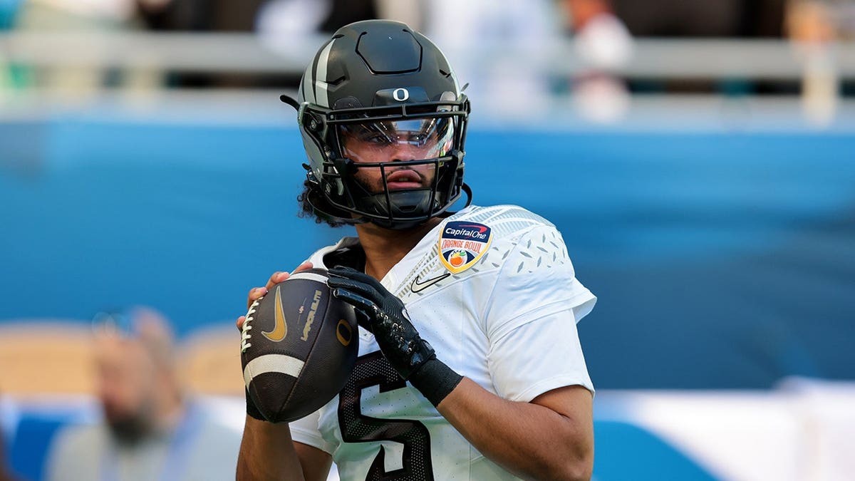 Oregon Ducks quarterback Dante Moore (5) warms up before the 2025 Orange Bowl at Hard Rock Stadium.