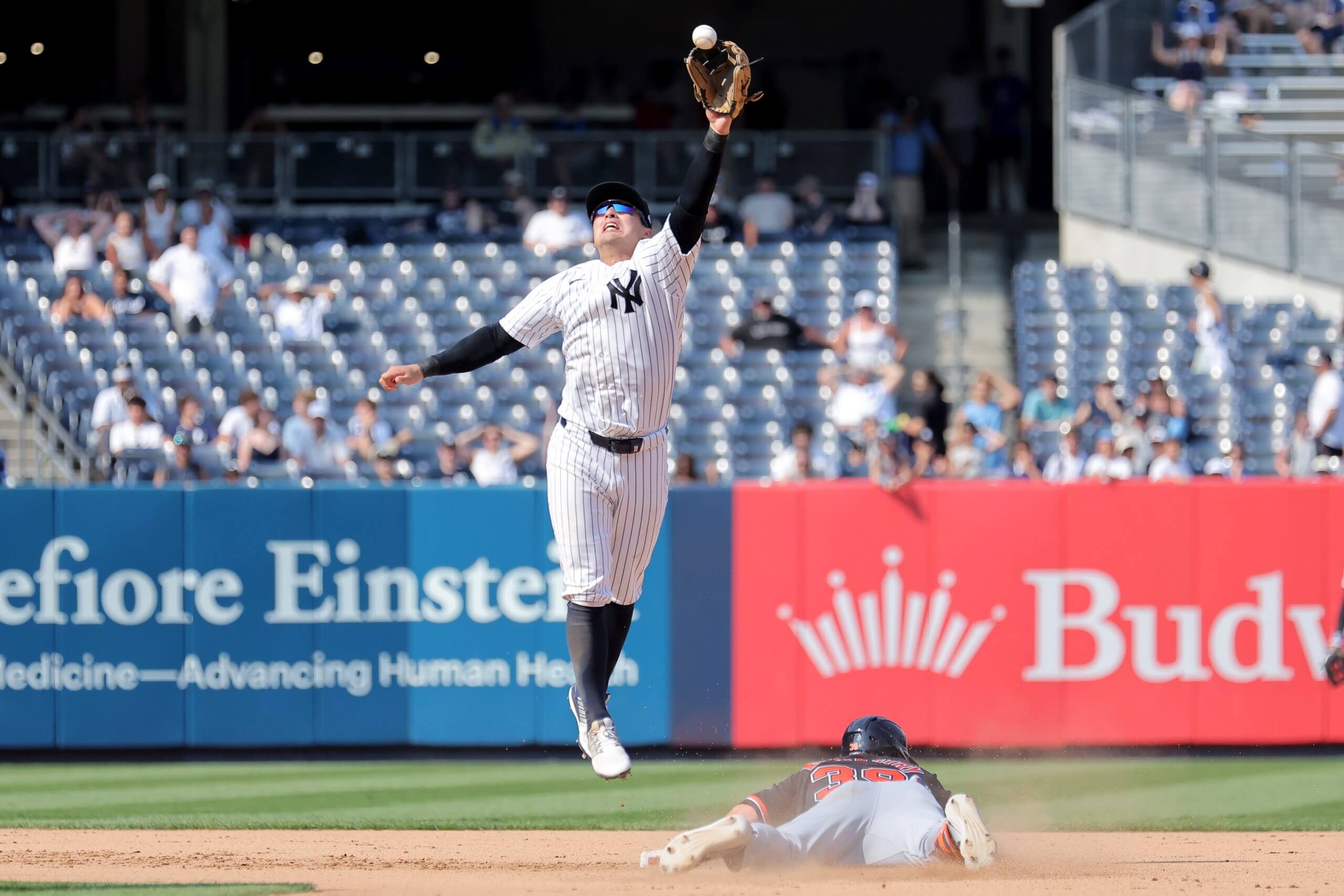 Anthony Volpe jumps but can't reach an errant throw from catcher Ali Sánchez in the 11th as the Tigers scored four runs.