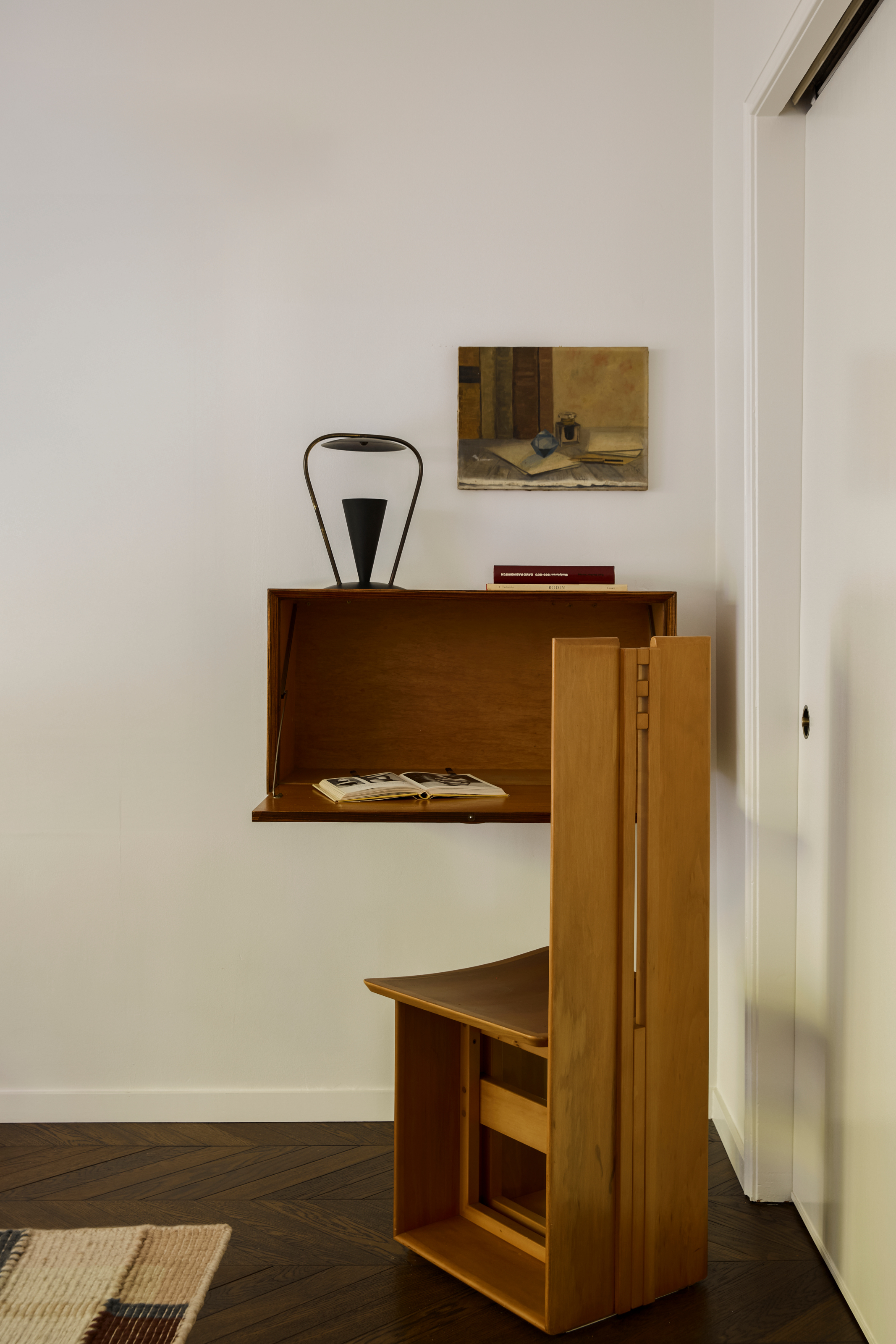 Fold-out wall desk and sculptural wood chair