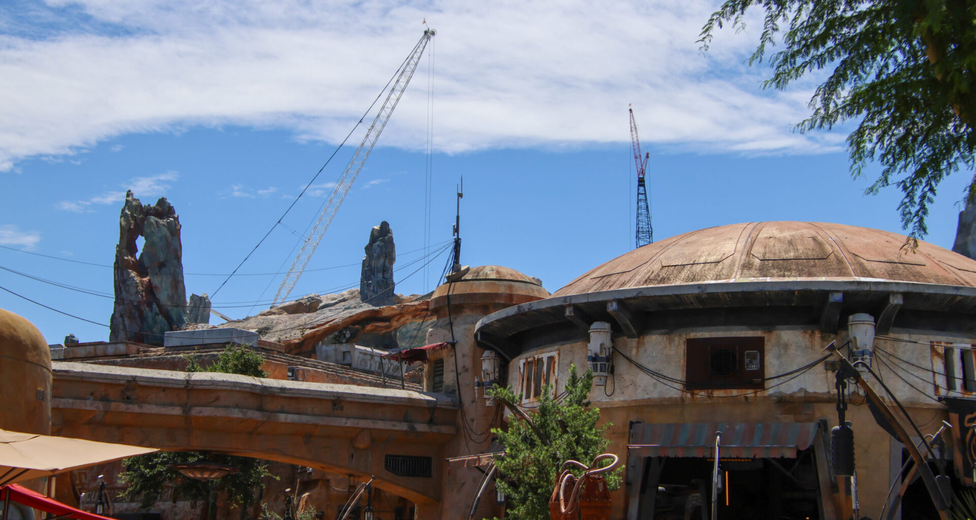 Construction of the upcoming Monsters, Inc. roller coaster continues to reshape the skyline of Disney’s Hollywood Studios, with a towering crane now visible from other areas of the park.