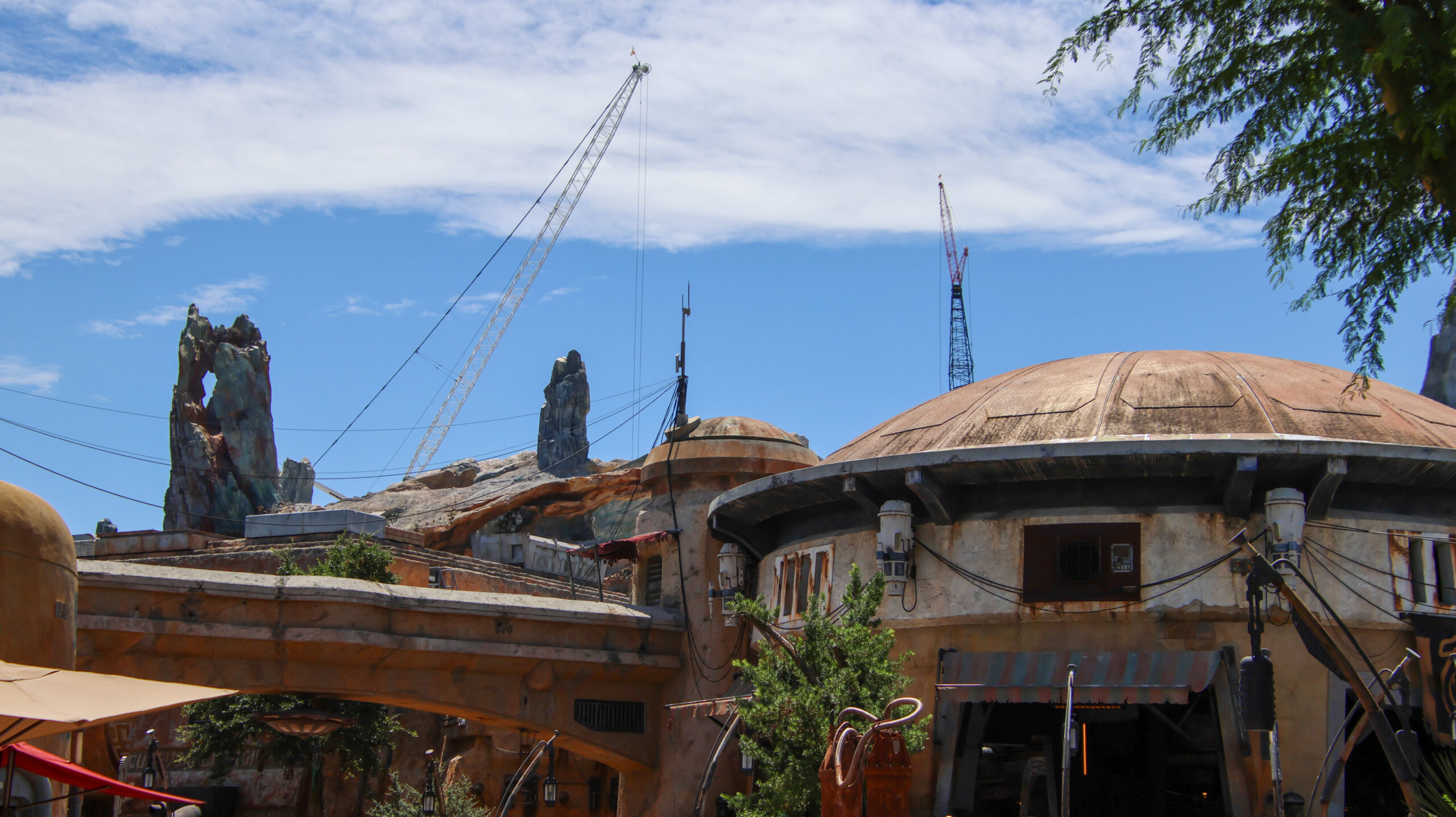 Construction of the upcoming Monsters, Inc. roller coaster continues to reshape the skyline of Disney’s Hollywood Studios, with a towering crane now visible from other areas of the park.