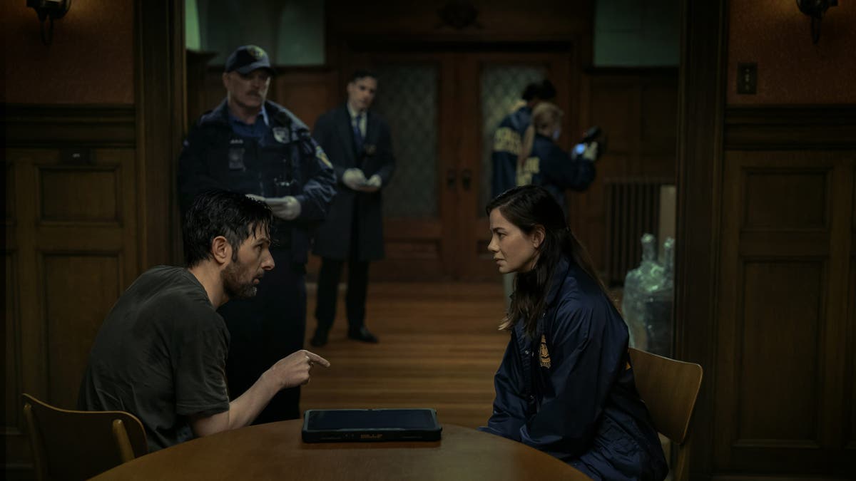 Adam Scott and Michelle Monaghan stand together in a scene from The Whisper Man.