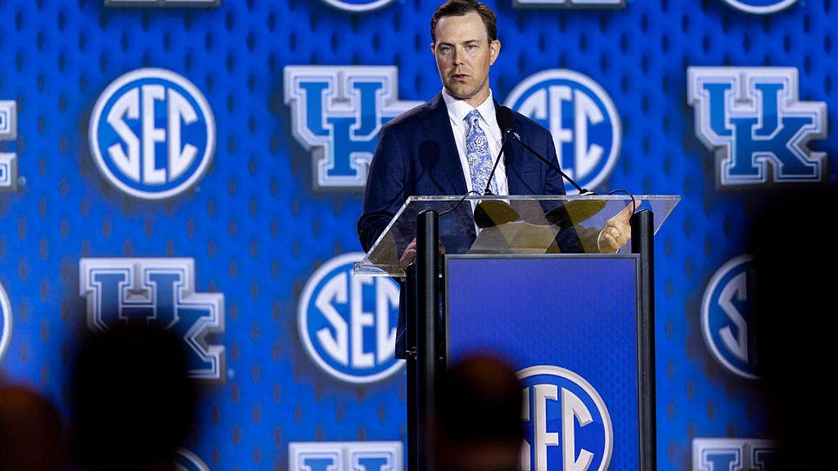 Will Stein speaks at a podium at SEC Football Media Day in Tampa, Florida.
