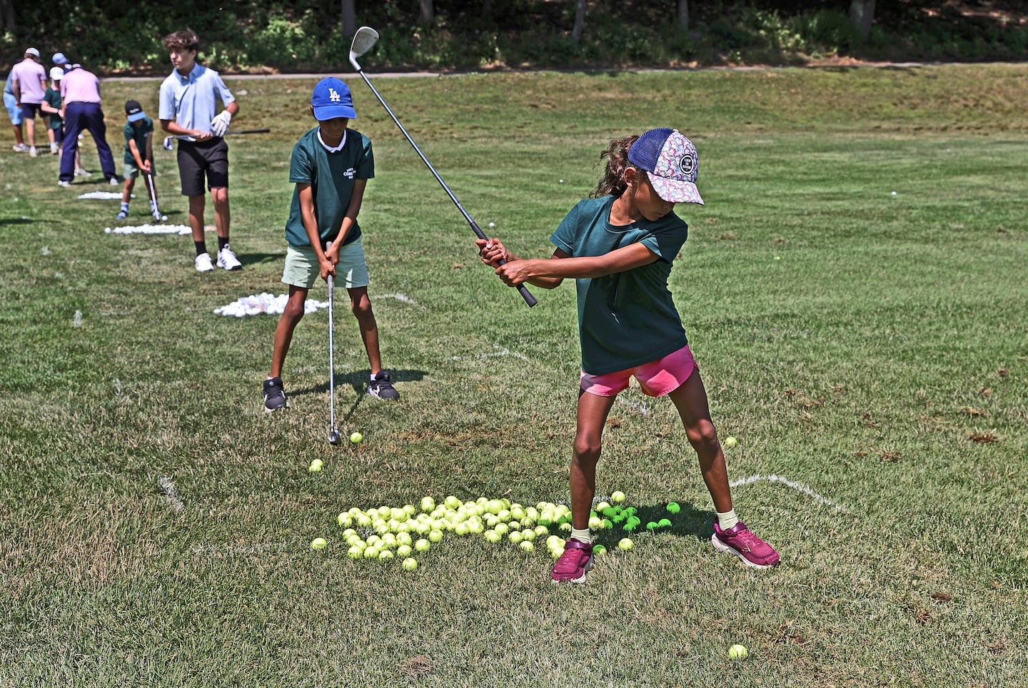 Ruby Paez and others were on the driving range at Boston Common Golf’s youth golf clinic. 
