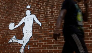 People walking by the LeBron James mosaic on 8th and Market Street on Tuesday.
