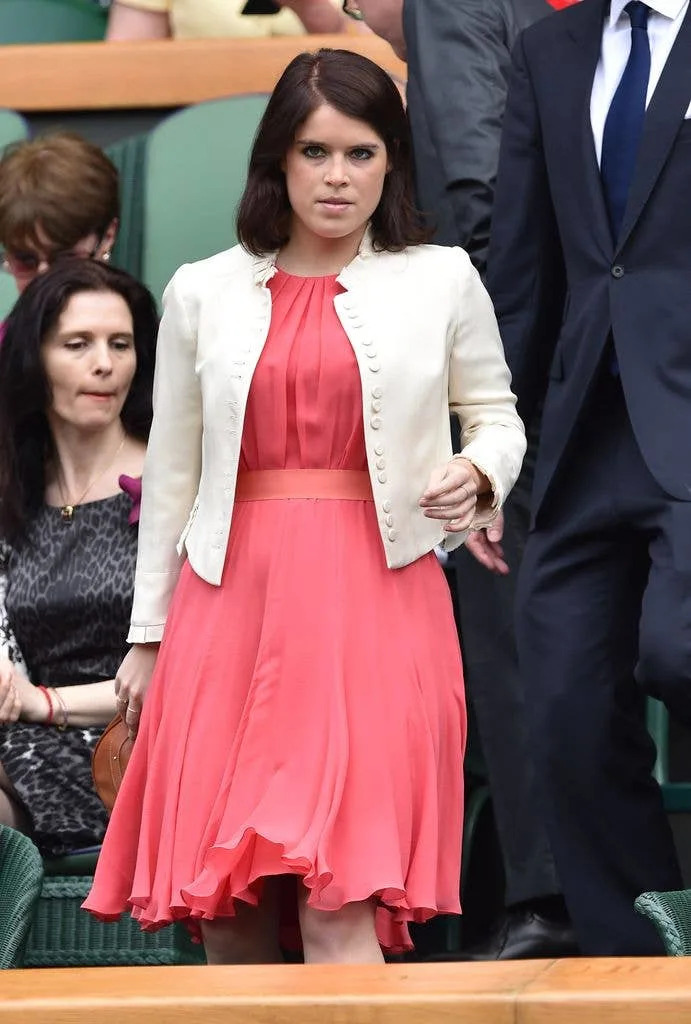 A photo of Princess Eugenie wearing a coral dress