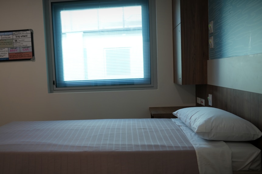 A made bed in a hospital