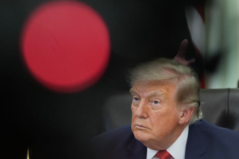 US President Donald Trump looks on during an announcement about Dulles International Airport renovations in the Oval Office of the White House in Washington, DC on July 29, 2026.