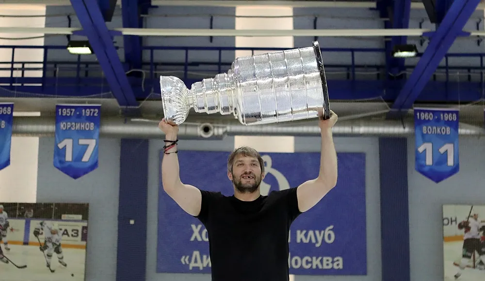 Alex Ovechkin holds up the Stanley Cup at Dynamo Moscow's complex