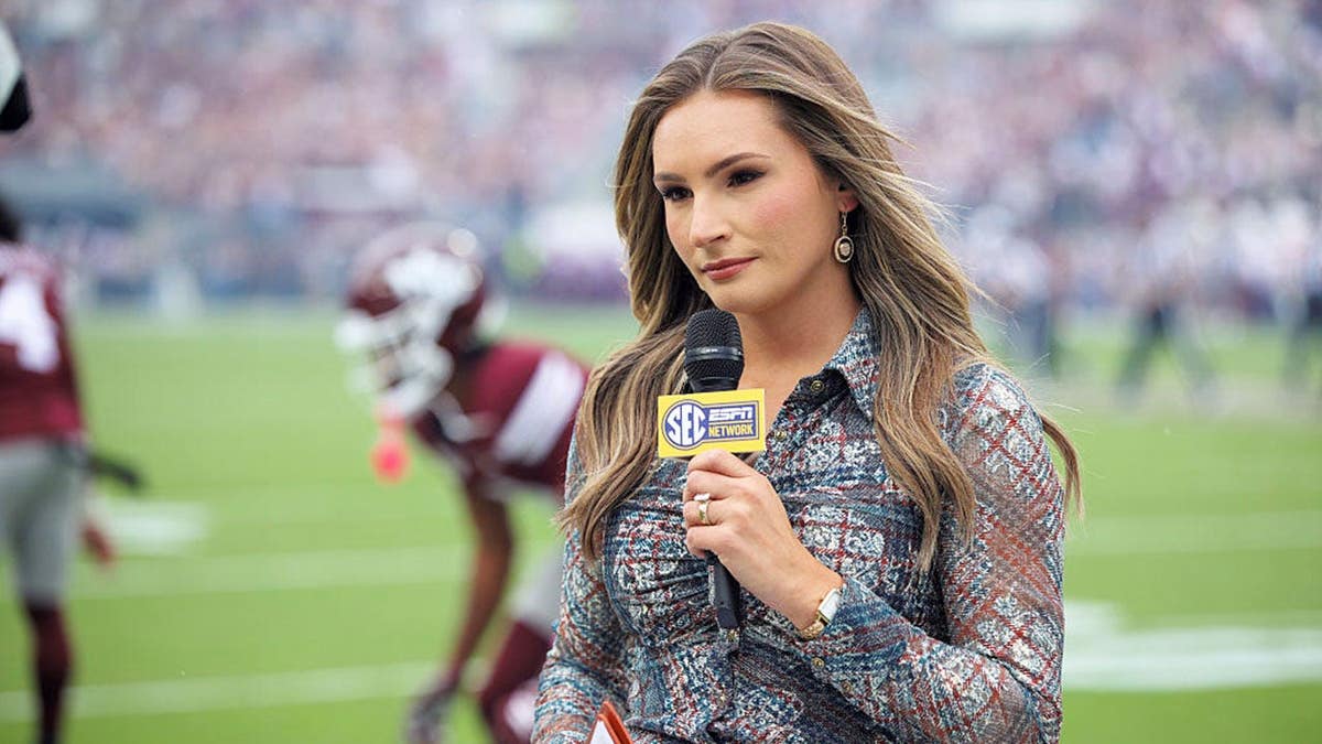 Alyssa Lang, ESPN reporter, stands during a college football game.