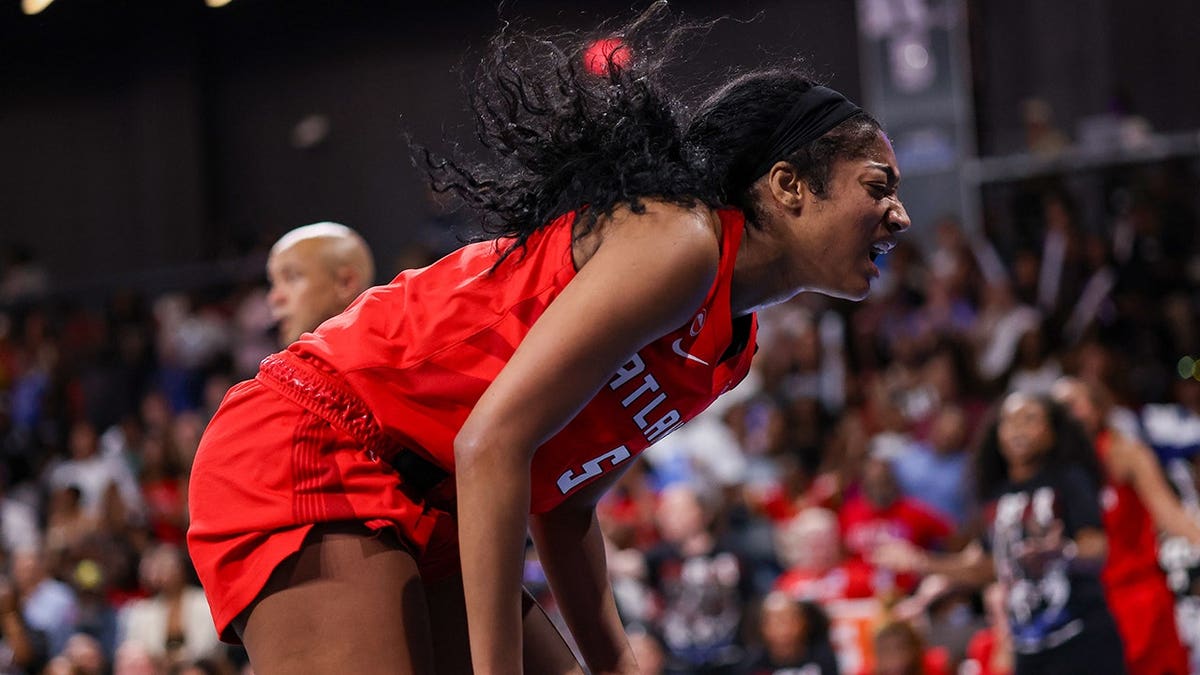 Angel Reese reacts after an injury on the court.