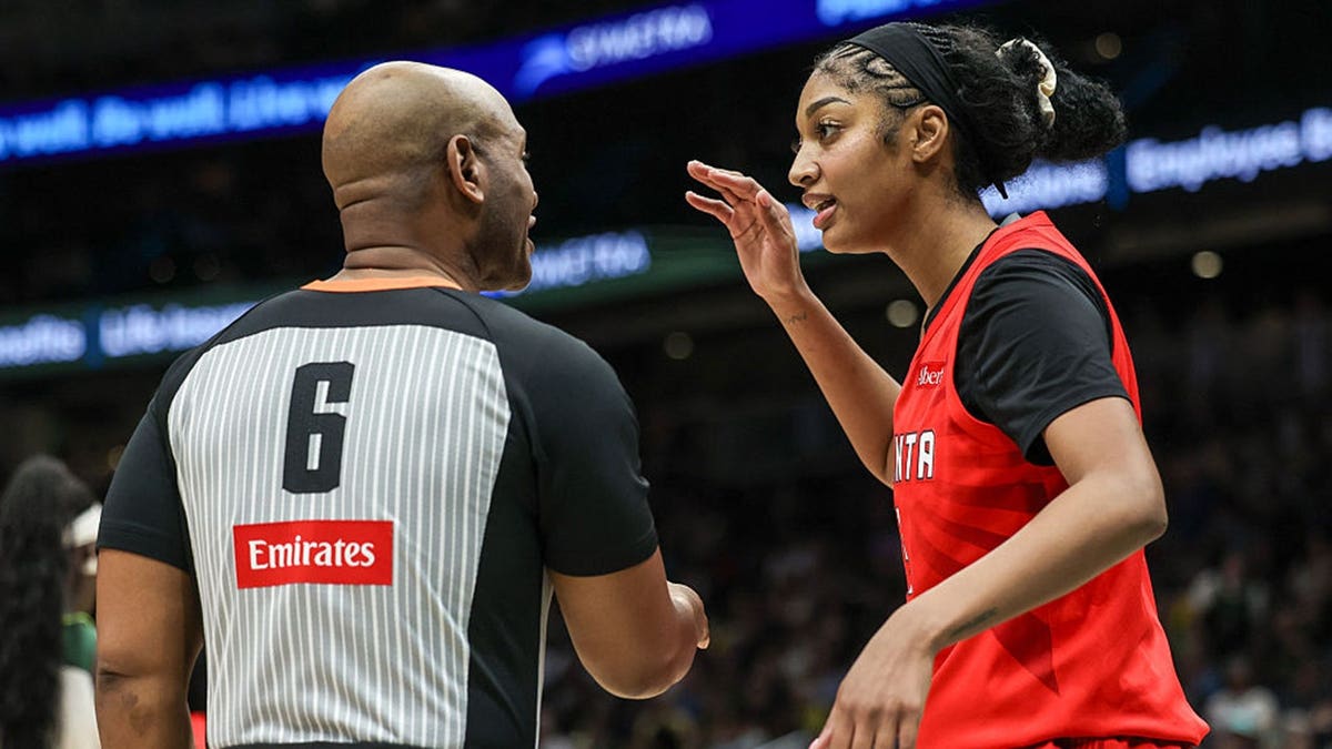 wnba player angel reese talks with a referee