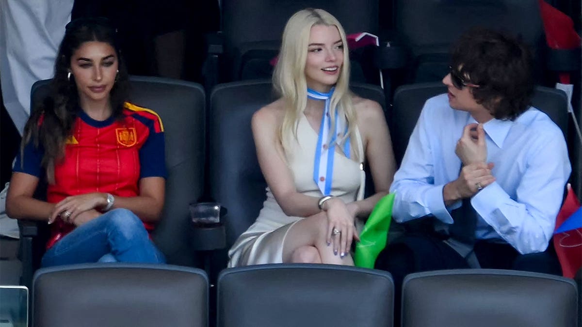 British-US actress Anya Taylor-Joy (C) and husband, US musician Malcolm McRae (R) are pictured prior to the 2026 World Cup football tournament final match between Spain and Argentina at the New York/New Jersey Stadium