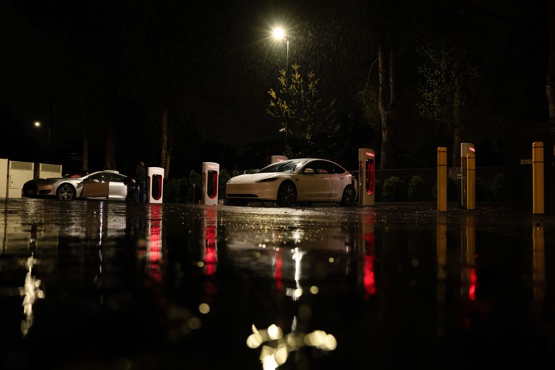 A Tesla charges in the rain at an electric vehicle charging station in Portland, Oregon.