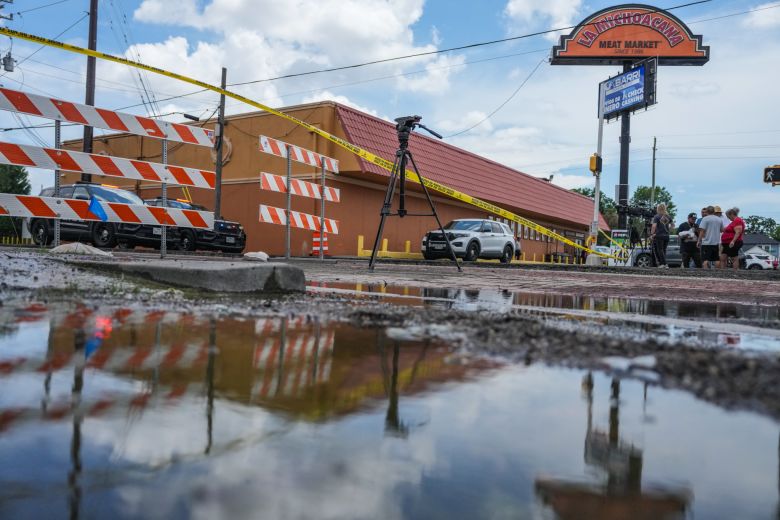 Police work on Canal Street in Houston, on Tuesday, July 7, 2026, after the shooting.