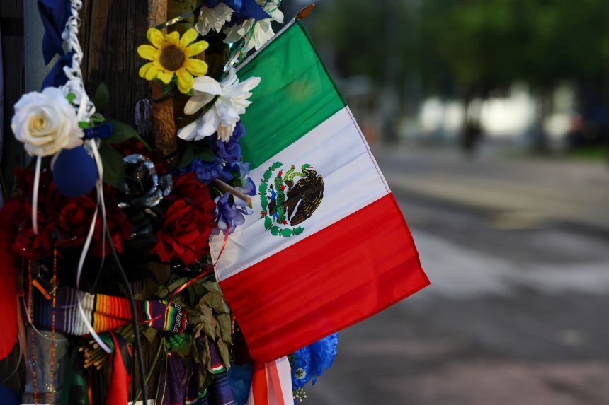 The flag of Mexico is seen at a memorial site where Mexican immigrant Lorenzo Salgado Araujo was fatally shot by an Immigration and Customs Enforcement (ICE) officer, Saturday, July 11, 2026, in Houston.
