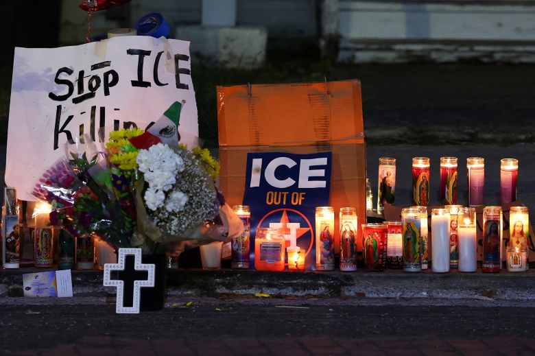 Flowers, candles and handwritten messages at a memorial site where Mexican immigrant Lorenzo Salgado Araujo was fatally shot.