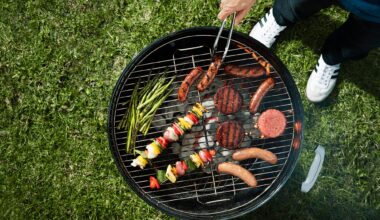 A man uses tongs to rotate food on a grill.