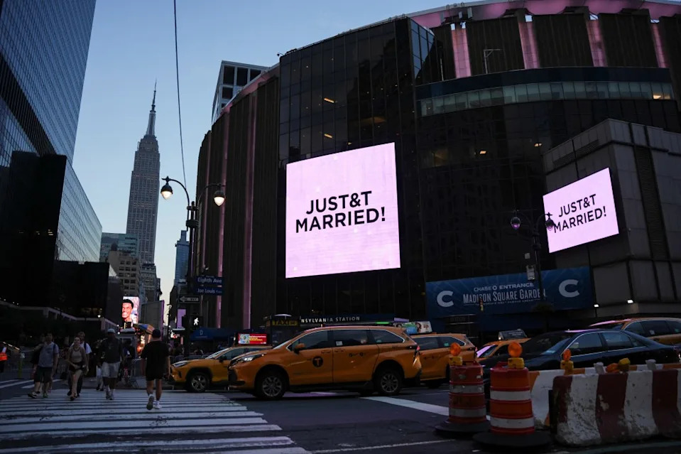 A screen displays a message referencing Taylor Swift and Travis Kelce being married outside Madison Square Garden on July 3, 2026. REUTERS