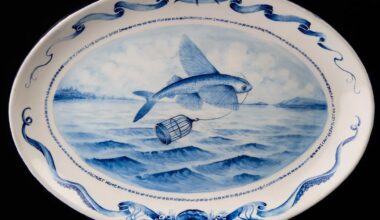 a white plate with a blue painting of a fish jumping from the water with a bird cage in its mouth