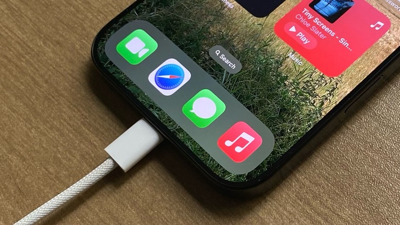 Close-up shot of an iPhone charging with a braided Apple cable