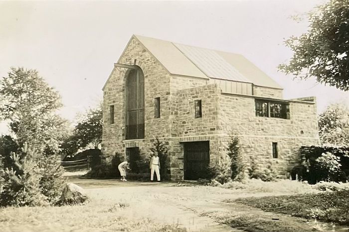 The home was built in 1932, and the plans name architect Lewis Welch. This view of the back shows garage-style doors that lead straight to the basement.