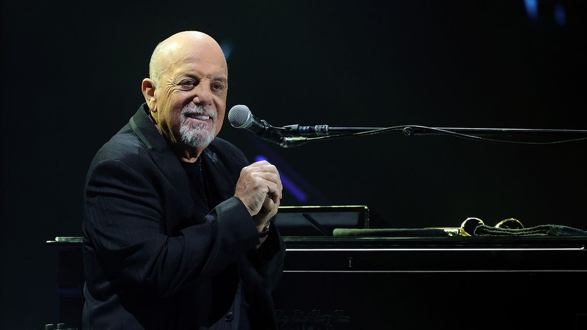 Billy Joel performs on stage at Allegiant Stadium.