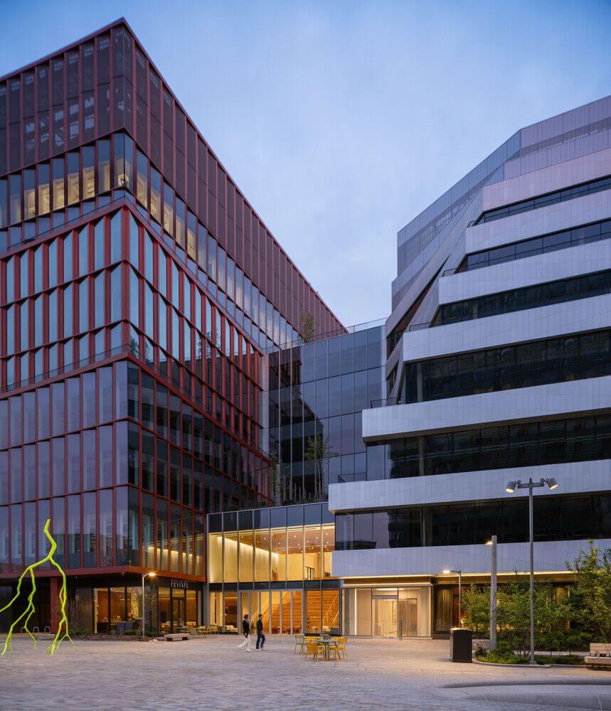 A transparent 3-story atrium connects the two new buildings.