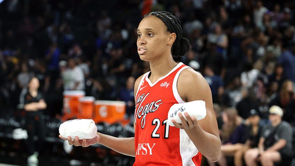 Brianna Turner #21 of the Las Vegas Aces throws autographed T-shirts to fans.